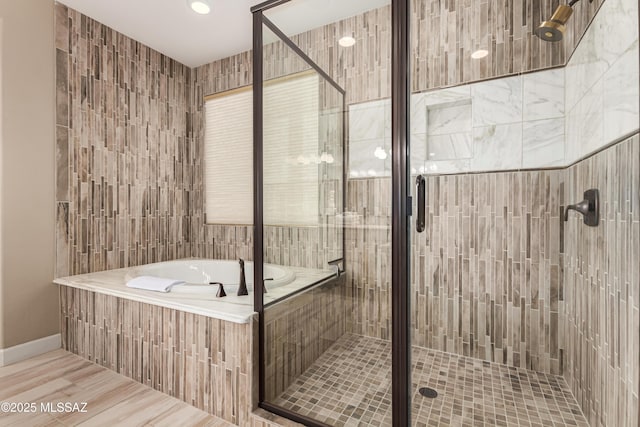 bathroom with a garden tub and a shower stall