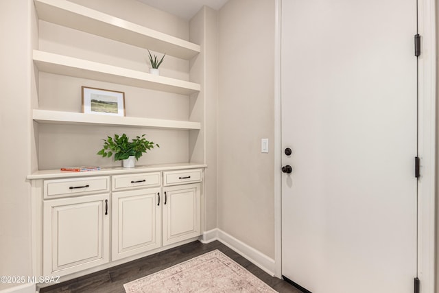 interior space with dark wood-style floors and baseboards