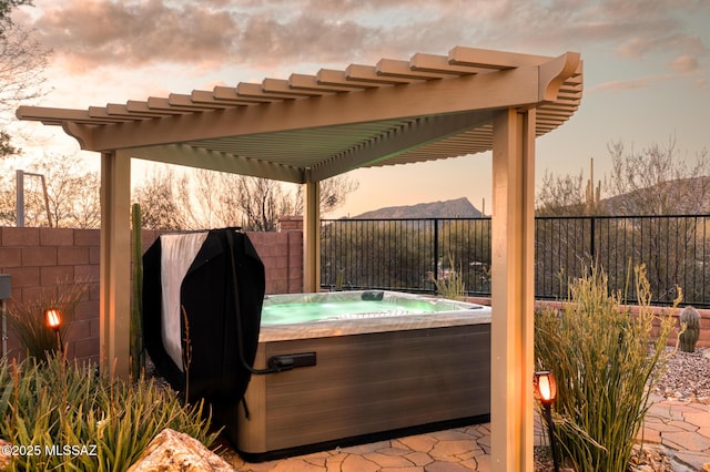 view of patio with a fenced backyard, a pergola, and a hot tub