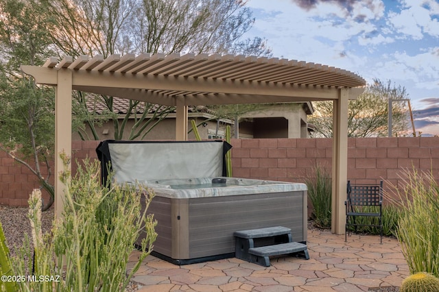 view of patio / terrace with fence, a pergola, and a hot tub