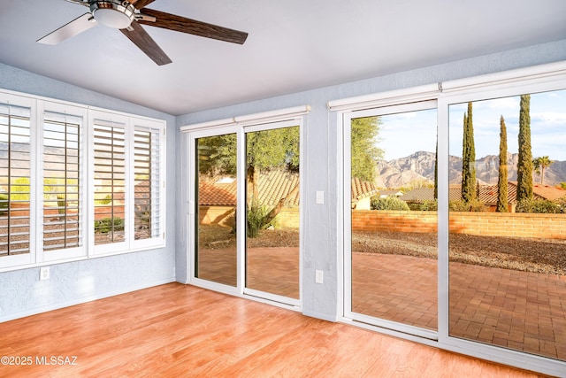 entryway featuring a mountain view, a ceiling fan, wood finished floors, and lofted ceiling