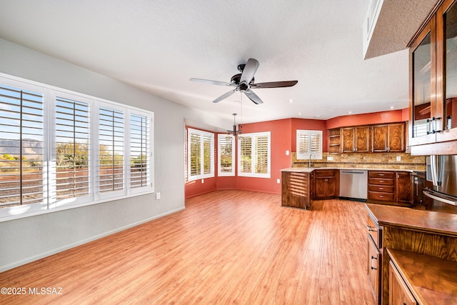 kitchen with baseboards, open shelves, a ceiling fan, light wood-style floors, and stainless steel dishwasher