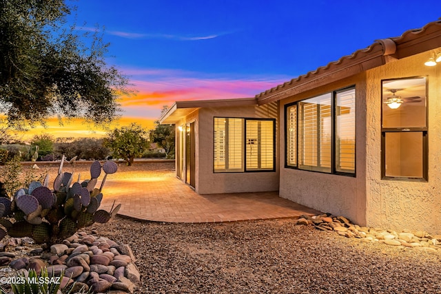 view of side of property featuring a patio area and stucco siding