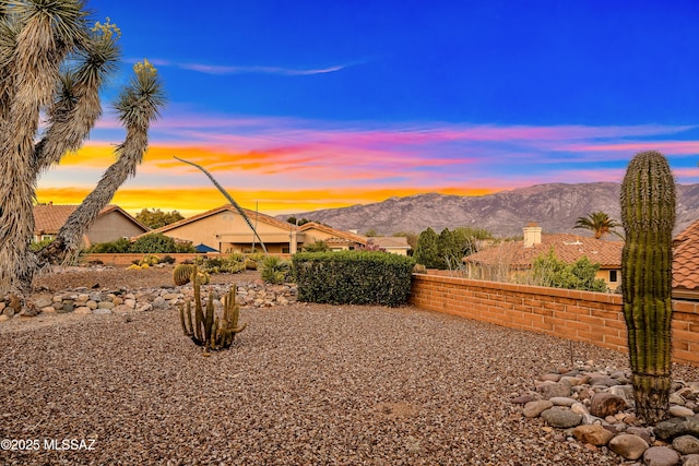 view of yard featuring a mountain view and fence