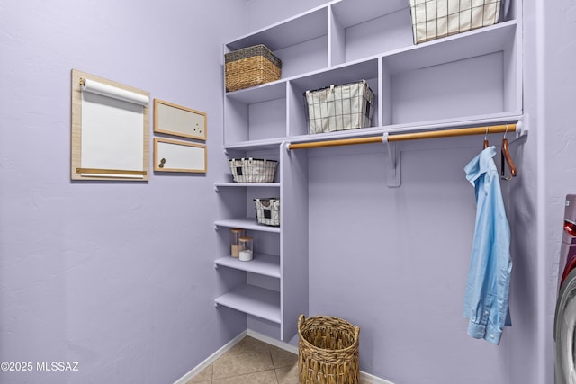 walk in closet with tile patterned flooring