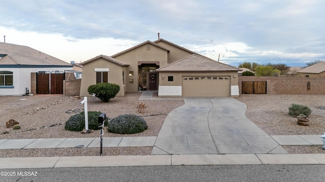 ranch-style house with stucco siding, driveway, a gate, fence, and an attached garage