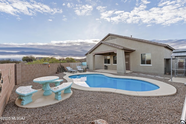 view of swimming pool with a ceiling fan, a patio, a fenced backyard, and a fenced in pool