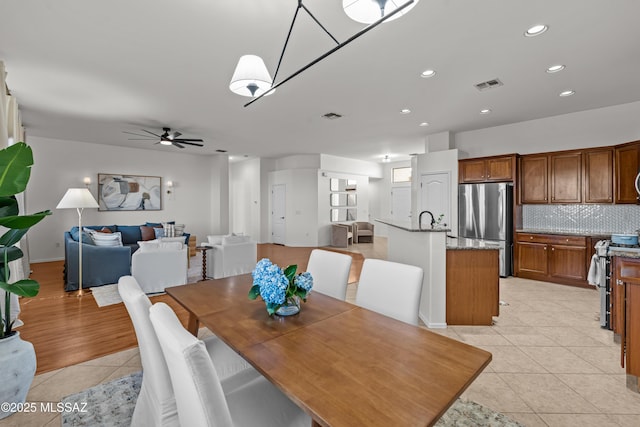 dining space with light tile patterned floors, recessed lighting, visible vents, and ceiling fan