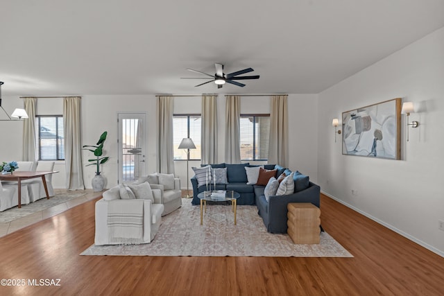 living area featuring plenty of natural light, a ceiling fan, and wood finished floors