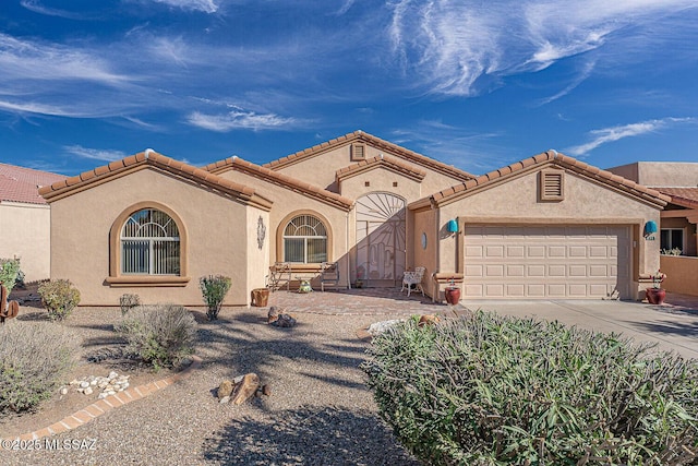 view of front of property featuring stucco siding, concrete driveway, and an attached garage