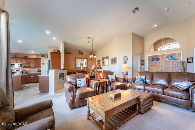 living room with recessed lighting, visible vents, light colored carpet, and high vaulted ceiling