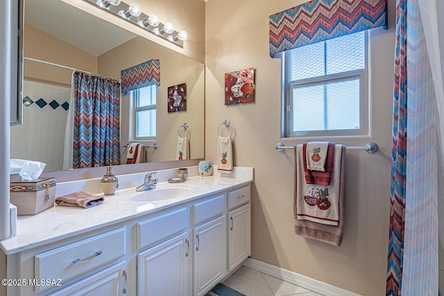 full bathroom featuring tile patterned floors, vanity, and baseboards