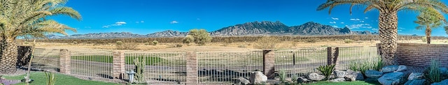 view of yard with fence and a mountain view