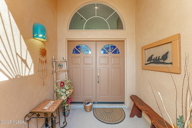 doorway to property with stucco siding