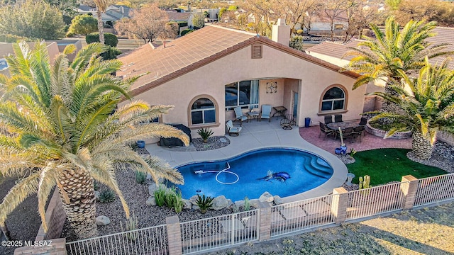 view of swimming pool with a patio area, a fenced in pool, and a fenced backyard