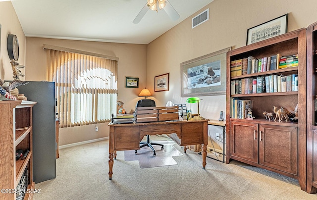 home office featuring baseboards, visible vents, a ceiling fan, and carpet