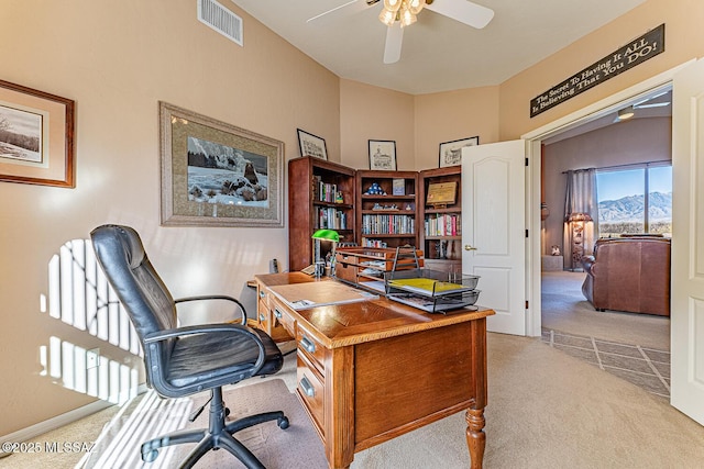 home office featuring visible vents, ceiling fan, and carpet flooring