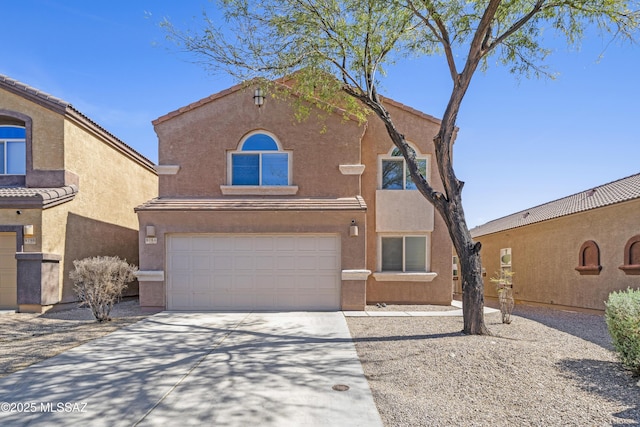 view of front of house featuring driveway, stucco siding, an attached garage, and a tiled roof