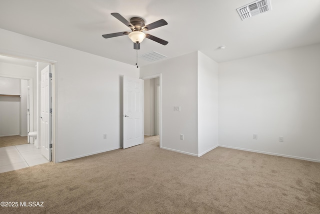 unfurnished bedroom with light colored carpet, visible vents, baseboards, and light tile patterned floors