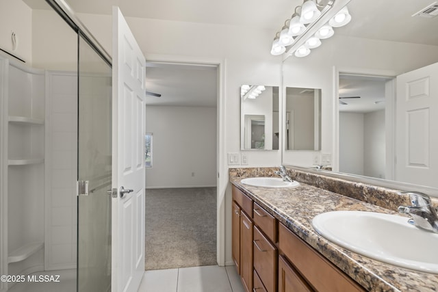full bathroom featuring a shower stall, visible vents, tile patterned flooring, and a sink