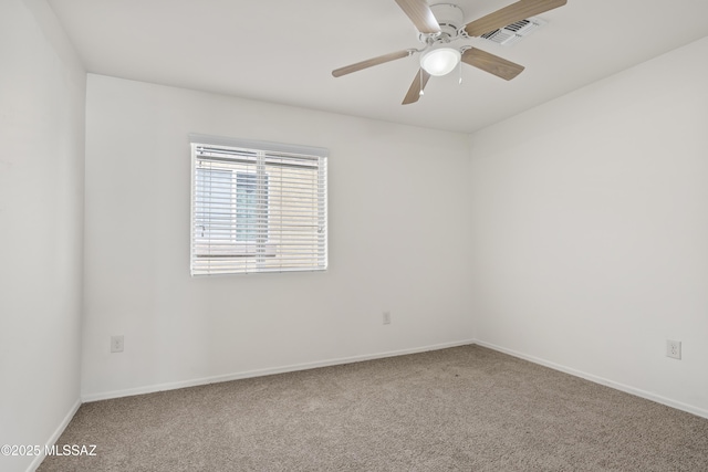 carpeted empty room with a ceiling fan, baseboards, and visible vents