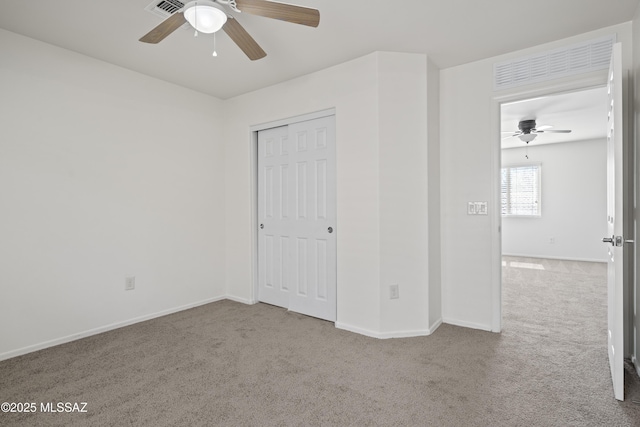 unfurnished bedroom with baseboards, carpet flooring, visible vents, and a closet