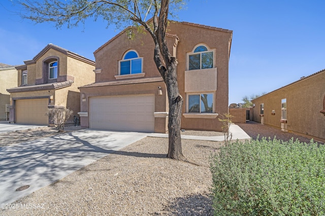 view of front of house with a tile roof, stucco siding, concrete driveway, and a garage
