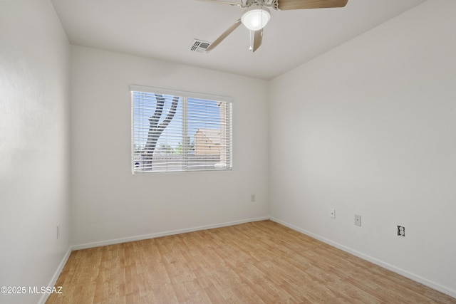 spare room featuring baseboards, visible vents, ceiling fan, and light wood-type flooring