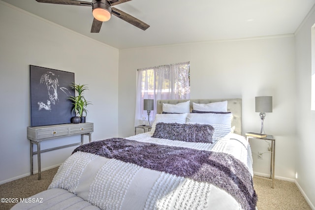 carpeted bedroom with ceiling fan, baseboards, and ornamental molding