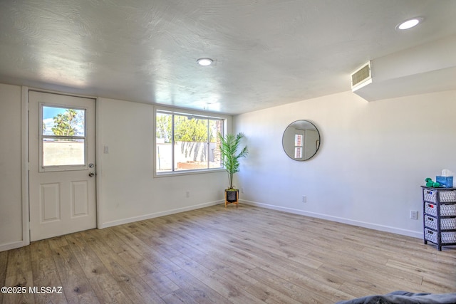 entrance foyer featuring recessed lighting, baseboards, visible vents, and wood finished floors