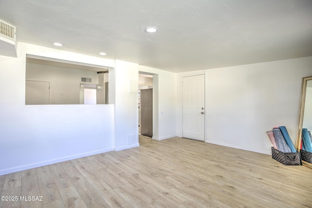 unfurnished room featuring recessed lighting, visible vents, and wood finished floors