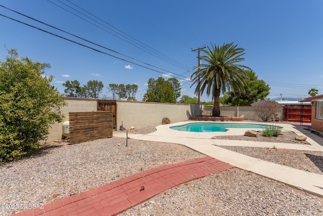 view of pool with a patio area, a fenced in pool, and a fenced backyard