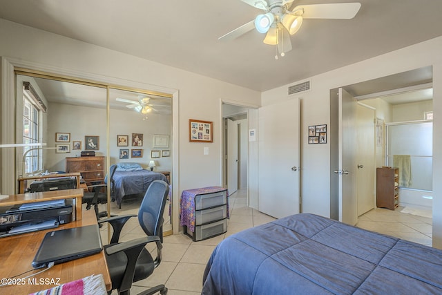 bedroom featuring visible vents, a closet, light tile patterned flooring, and a ceiling fan