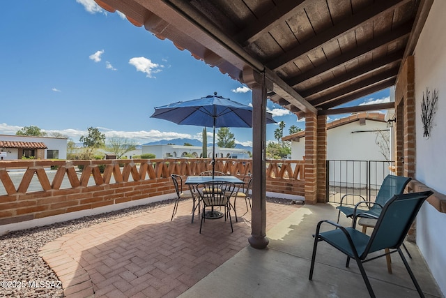 view of patio / terrace with outdoor dining space and fence