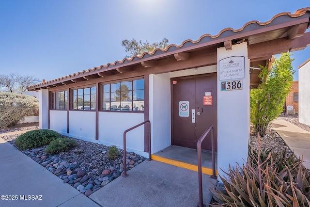 entrance to property featuring stucco siding