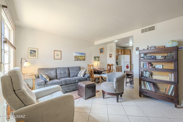 living room with light tile patterned floors and visible vents