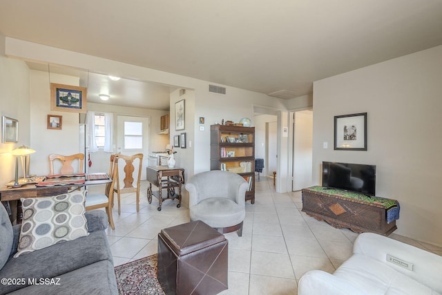 living room featuring light tile patterned floors and visible vents