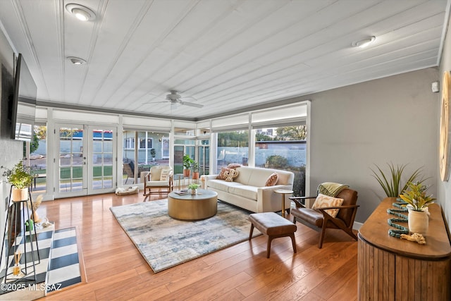 sunroom / solarium with french doors and a ceiling fan