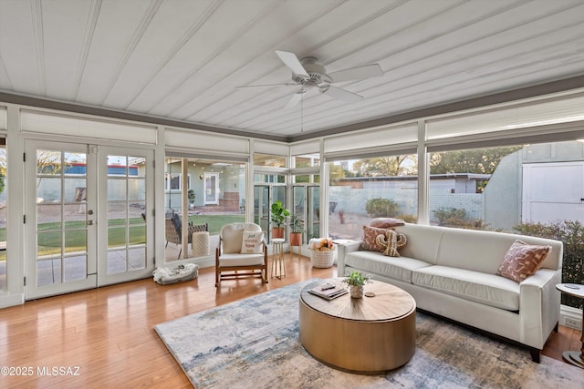 sunroom / solarium featuring french doors and ceiling fan