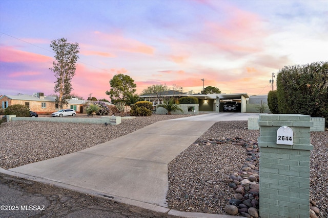 ranch-style house with a carport and driveway