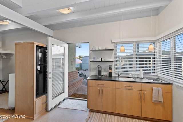 kitchen featuring open shelves, vaulted ceiling with beams, a sink, pendant lighting, and dark countertops