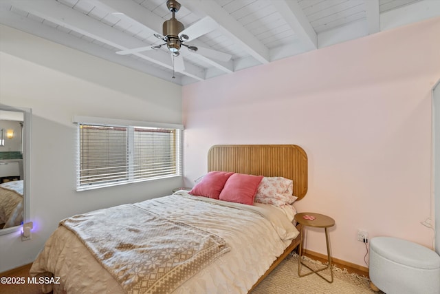 bedroom featuring beamed ceiling, a ceiling fan, and baseboards