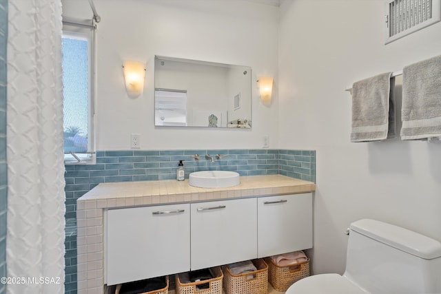 full bath with visible vents, toilet, and vanity