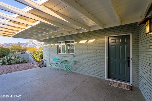 view of patio / terrace with a mountain view and fence