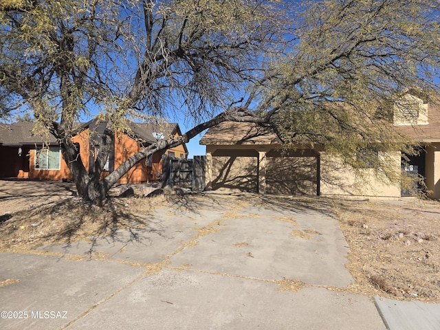 exterior space with concrete driveway and fence