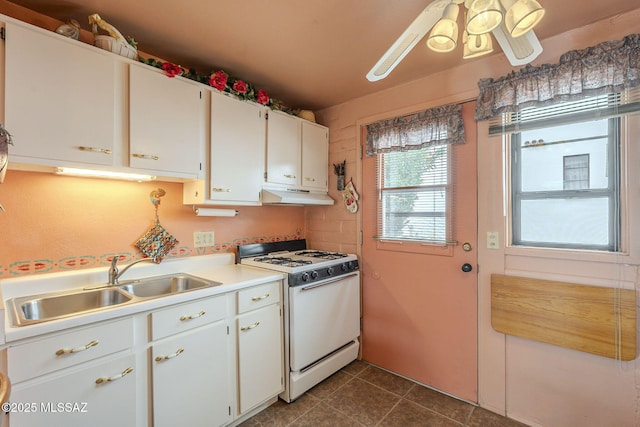 kitchen featuring a sink, light countertops, ceiling fan, under cabinet range hood, and white range with gas cooktop
