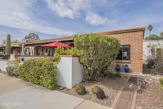 view of front of house featuring brick siding
