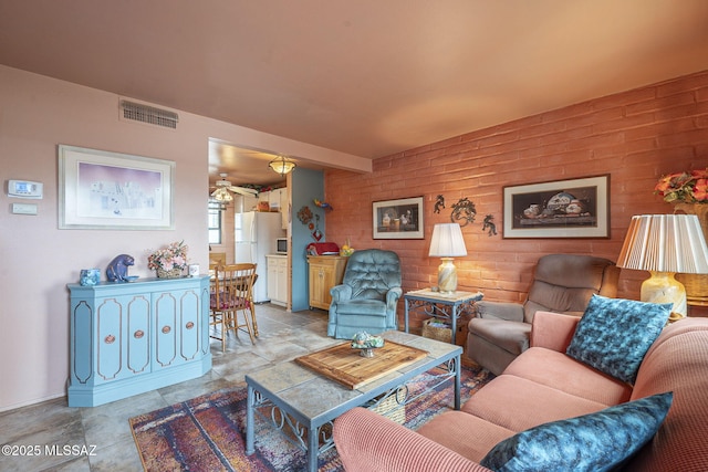 living room featuring visible vents and a ceiling fan