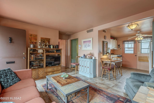 living area with visible vents and a ceiling fan