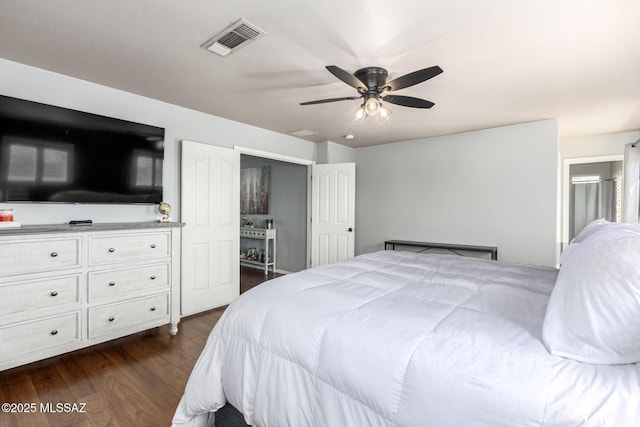 bedroom with visible vents, dark wood finished floors, and a ceiling fan